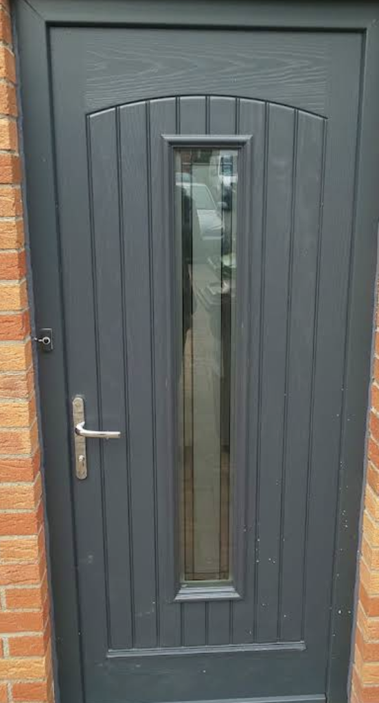 Anthracite composite front door with a tall glass panel and silver handle